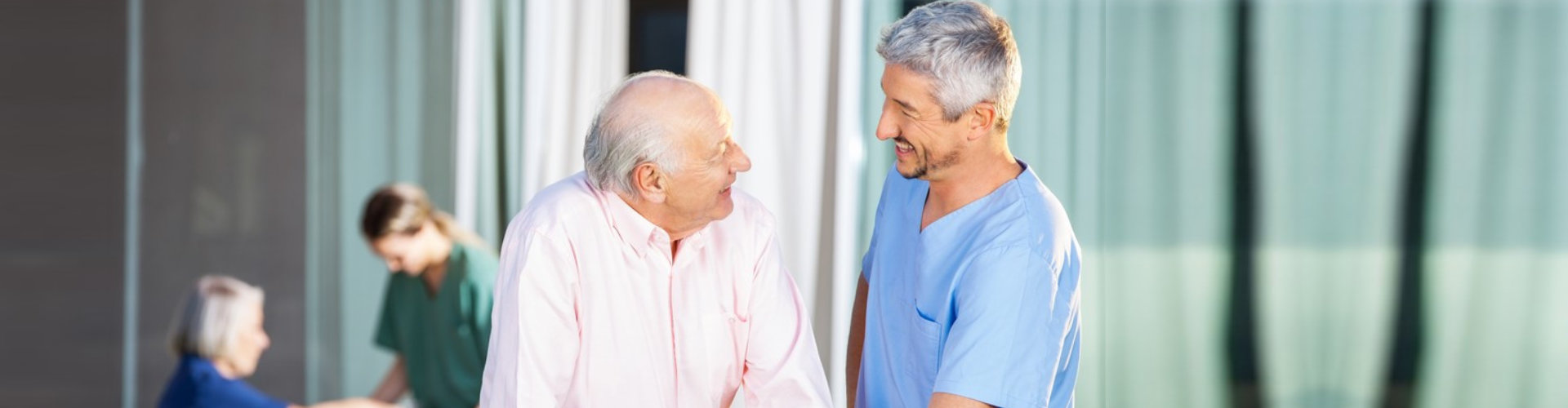 caregiver smiling to a senior man