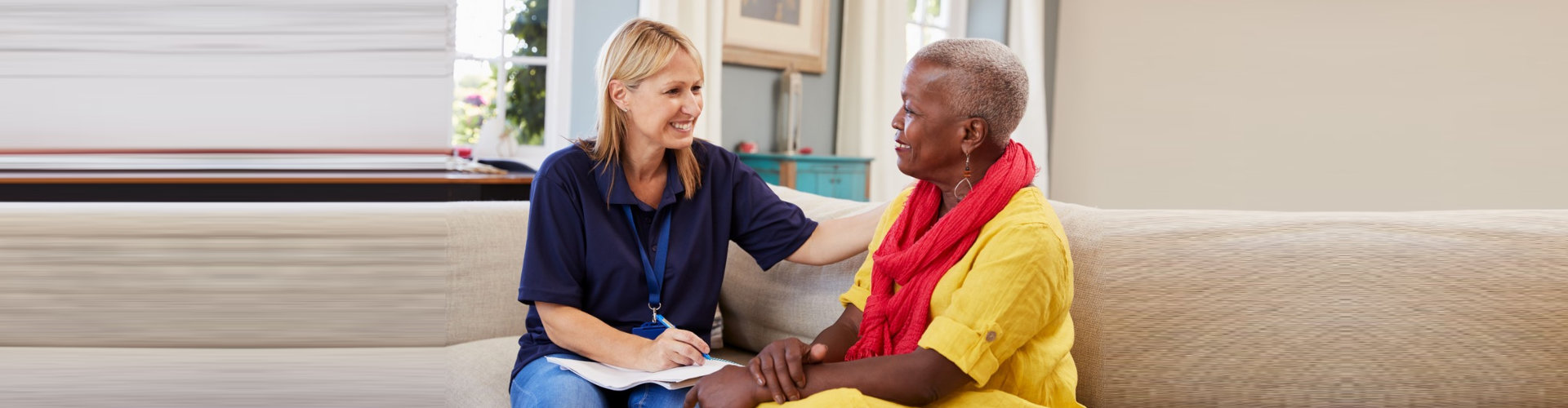 caregiver smiling to a senior woman